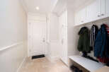 Step into this inviting entryway, featuring a stylish mudroom with ample storage.
