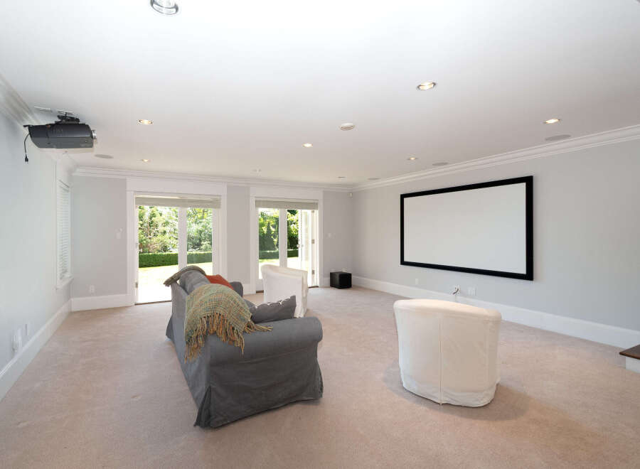 Step into luxury with this stunning home theater! Featuring a large screen, comfortable seating, and a state-of-the-art projector, this space is perfect for movie nights and entertaining guests.
