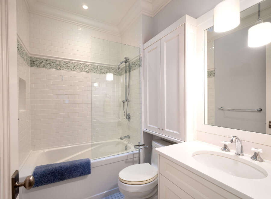 Step into this beautifully designed bathroom, featuring a pristine white vanity and a sleek, modern sink.