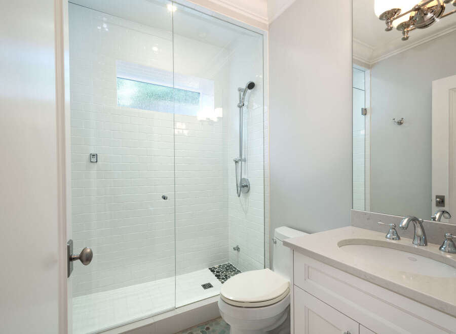 Step into this beautifully designed bathroom featuring a modern glass-enclosed shower, perfect for a refreshing start to your day.