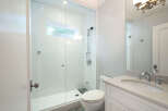 Step into this beautifully designed bathroom featuring a modern glass-enclosed shower, perfect for a refreshing start to your day.