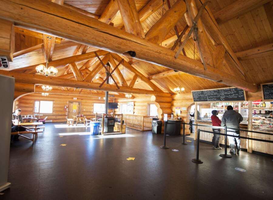 Step into a charming log cabin cafe, perfect for a cozy retreat.
