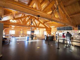 Step into a charming log cabin cafe, perfect for a cozy retreat.