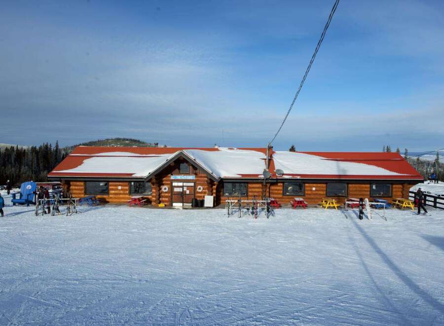 Nestled in a snowy landscape, this charming property offers a cozy retreat.