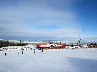Enjoy the winter wonderland at this stunning ski resort! This property features a spacious lodge with a cozy atmosphere, perfect for warming up after a day on the slopes.