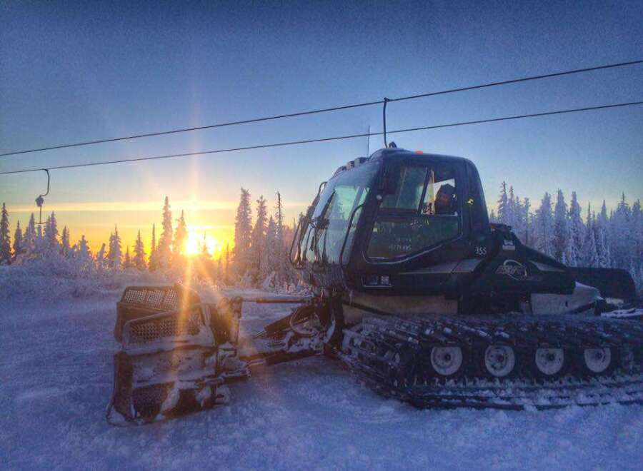 Experience the tranquility of winter in this stunning property! This image showcases a snow groomer preparing the slopes, promising pristine conditions for your next adventure.