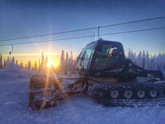 Experience the tranquility of winter in this stunning property! This image showcases a snow groomer preparing the slopes, promising pristine conditions for your next adventure.
