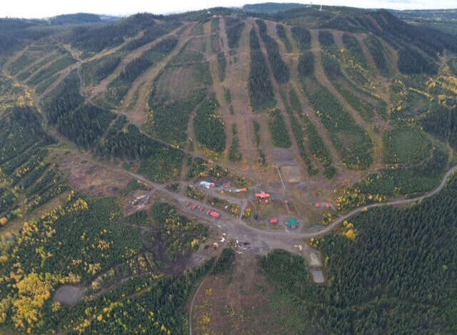 An aerial view showcases a stunning mountain landscape, ideal for outdoor enthusiasts and potential real estate opportunities.
