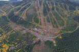 An aerial view showcases a stunning mountain landscape, ideal for outdoor enthusiasts and potential real estate opportunities.