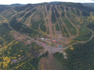 An aerial view showcases a stunning mountain landscape, ideal for outdoor enthusiasts and potential real estate opportunities.