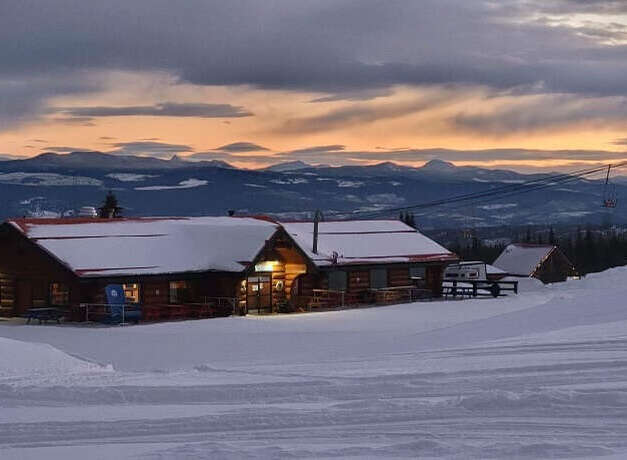 Nestled in a winter wonderland, this charming property offers a cozy retreat with stunning mountain views.