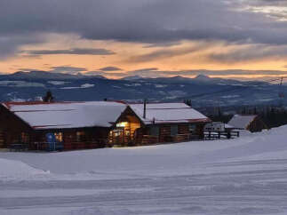 Nestled in a winter wonderland, this charming property offers a cozy retreat with stunning mountain views.