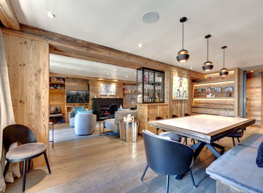 Experience luxury living in this stunning property, featuring exquisite wooden accents and a cozy fireplace.