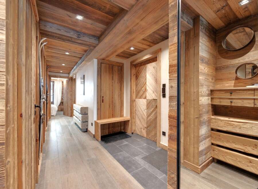 Step into rustic elegance with this stunning hallway, showcasing exquisite wooden paneling and a warm, inviting atmosphere.
