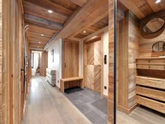 Step into rustic elegance with this stunning hallway, showcasing exquisite wooden paneling and a warm, inviting atmosphere.