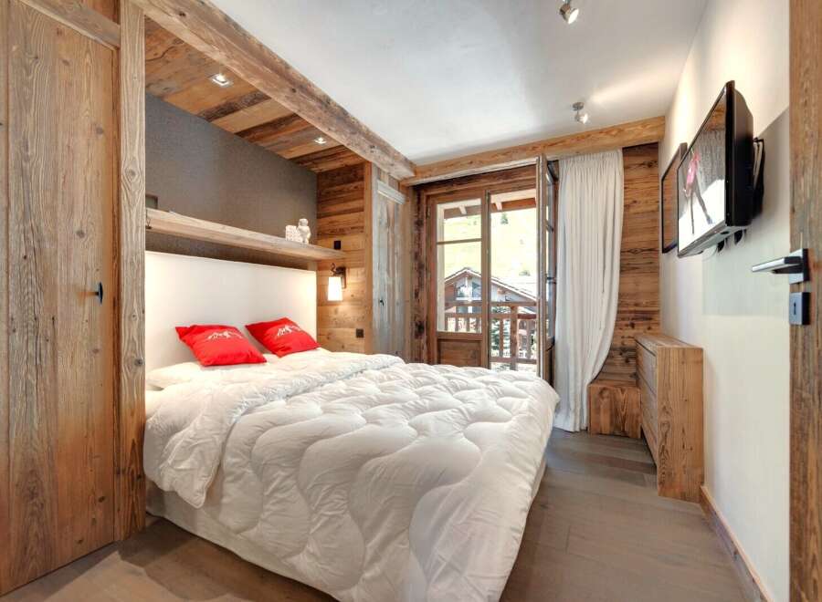 This cozy bedroom features rustic wooden accents, creating a warm and inviting atmosphere.