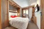 This cozy bedroom features rustic wooden accents, creating a warm and inviting atmosphere.
