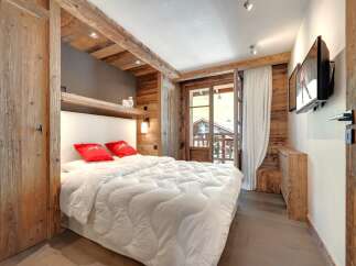 This cozy bedroom features rustic wooden accents, creating a warm and inviting atmosphere.