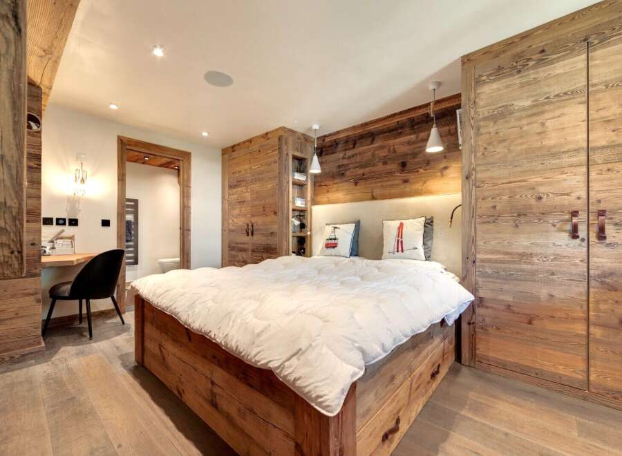 This stunning bedroom showcases rustic elegance with its wooden accents and cozy ambiance.