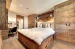 This stunning bedroom showcases rustic elegance with its wooden accents and cozy ambiance.
