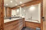 Experience luxury in this stunning bathroom featuring rustic wooden accents and modern design.