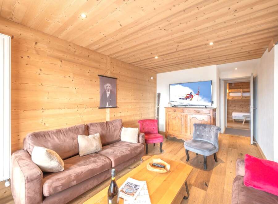 Experience the warmth of this inviting living space, featuring beautiful wooden paneling and a cozy atmosphere.