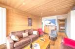 Experience the warmth of this inviting living space, featuring beautiful wooden paneling and a cozy atmosphere.