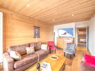 Experience the warmth of this inviting living space, featuring beautiful wooden paneling and a cozy atmosphere.