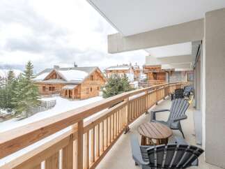Enjoy breathtaking mountain views from this charming balcony.