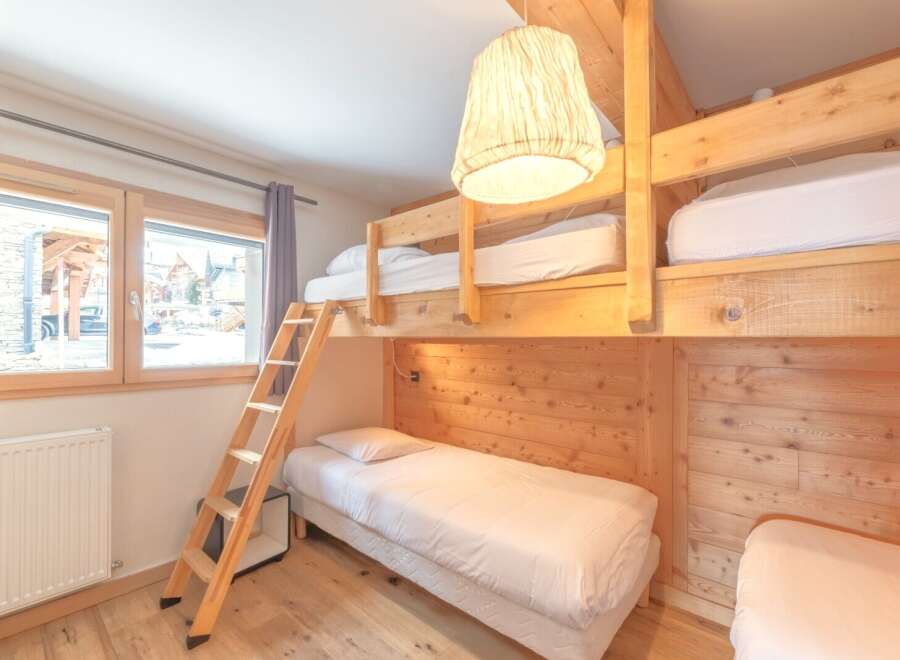 This cozy bedroom features a unique bunk bed setup, perfect for families or groups.