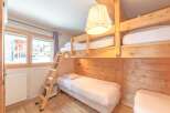 This cozy bedroom features a unique bunk bed setup, perfect for families or groups.