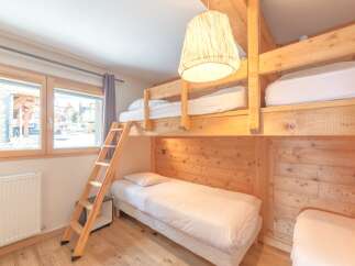 This cozy bedroom features a unique bunk bed setup, perfect for families or groups.