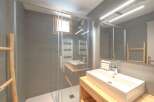 Step into this modern bathroom, featuring a sleek glass shower enclosure and contemporary design.