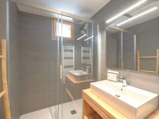 Step into this modern bathroom, featuring a sleek glass shower enclosure and contemporary design.