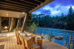 Experience luxury living with this stunning property featuring a spacious deck overlooking a serene river.