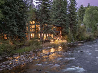 Nestled amidst lush greenery, this stunning property offers a serene escape with its riverfront location.
