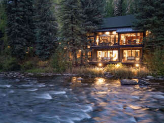 Nestled amidst lush greenery, this stunning property offers a serene escape with its riverfront location.