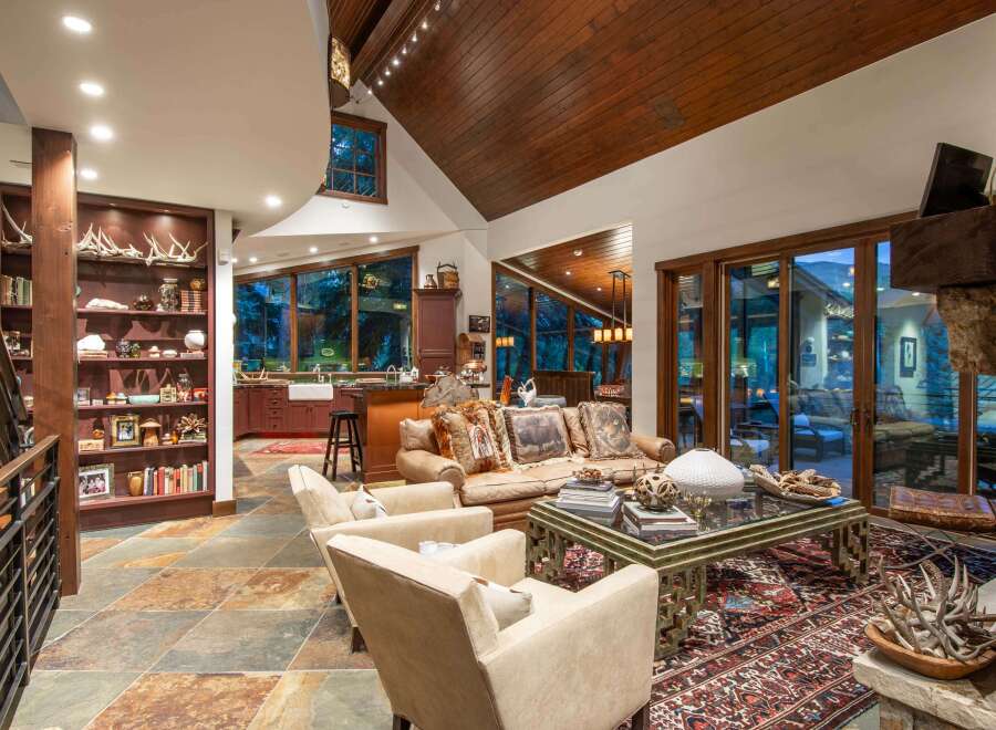 This luxurious living space showcases a stunning blend of rustic charm and modern elegance.