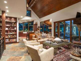 This luxurious living space showcases a stunning blend of rustic charm and modern elegance.