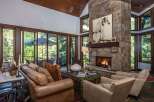 Experience luxury living in this stunning property featuring a cozy fireplace and expansive windows that flood the space with natural light.