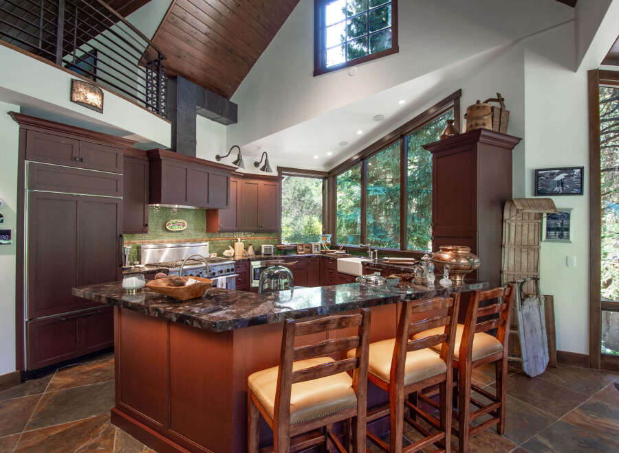 This stunning kitchen boasts a warm and inviting atmosphere, perfect for culinary enthusiasts.