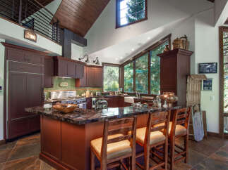 This stunning kitchen boasts a warm and inviting atmosphere, perfect for culinary enthusiasts.