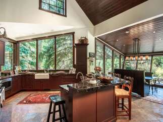This stunning kitchen boasts a seamless blend of rustic charm and modern elegance.
