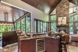 This stunning kitchen boasts a luxurious design with a granite countertop and a built-in wine cooler.