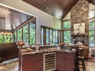 This stunning kitchen boasts a luxurious design with a granite countertop and a built-in wine cooler.