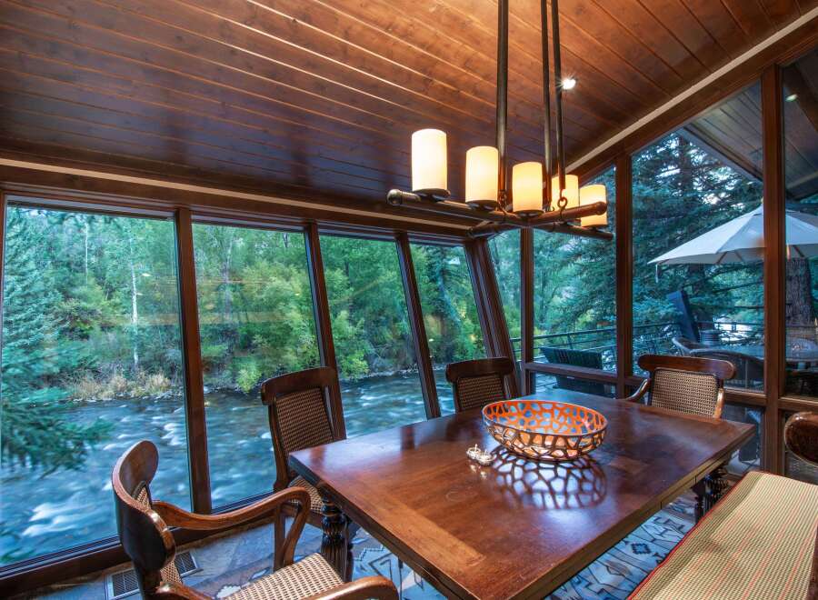 Experience the tranquility of riverside living in this stunning dining room.