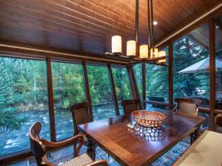 Experience the tranquility of riverside living in this stunning dining room.