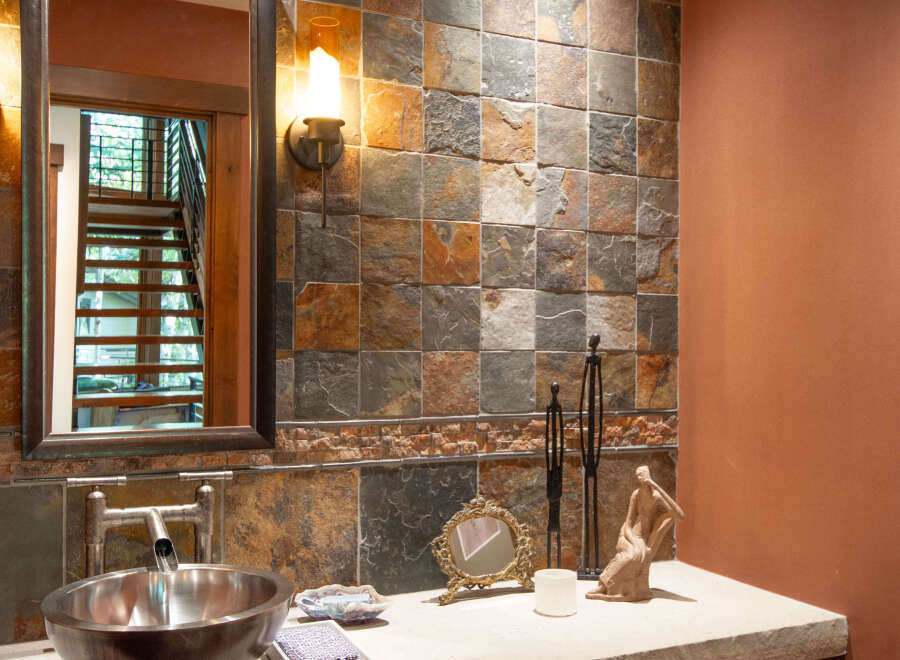 This stunning bathroom showcases a unique blend of rustic and modern design elements.