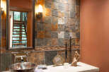 This stunning bathroom showcases a unique blend of rustic and modern design elements.