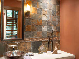 This stunning bathroom showcases a unique blend of rustic and modern design elements.